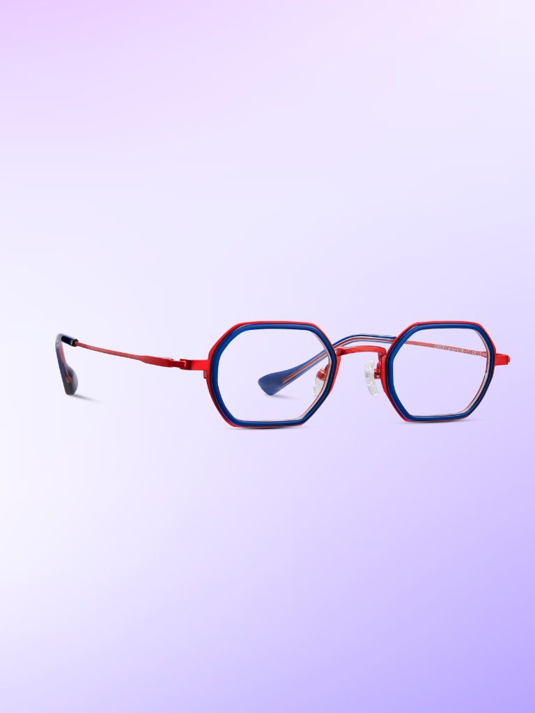 Red and blue geometric eyeglasses with thin frames displayed on a pastel purple gradient background.