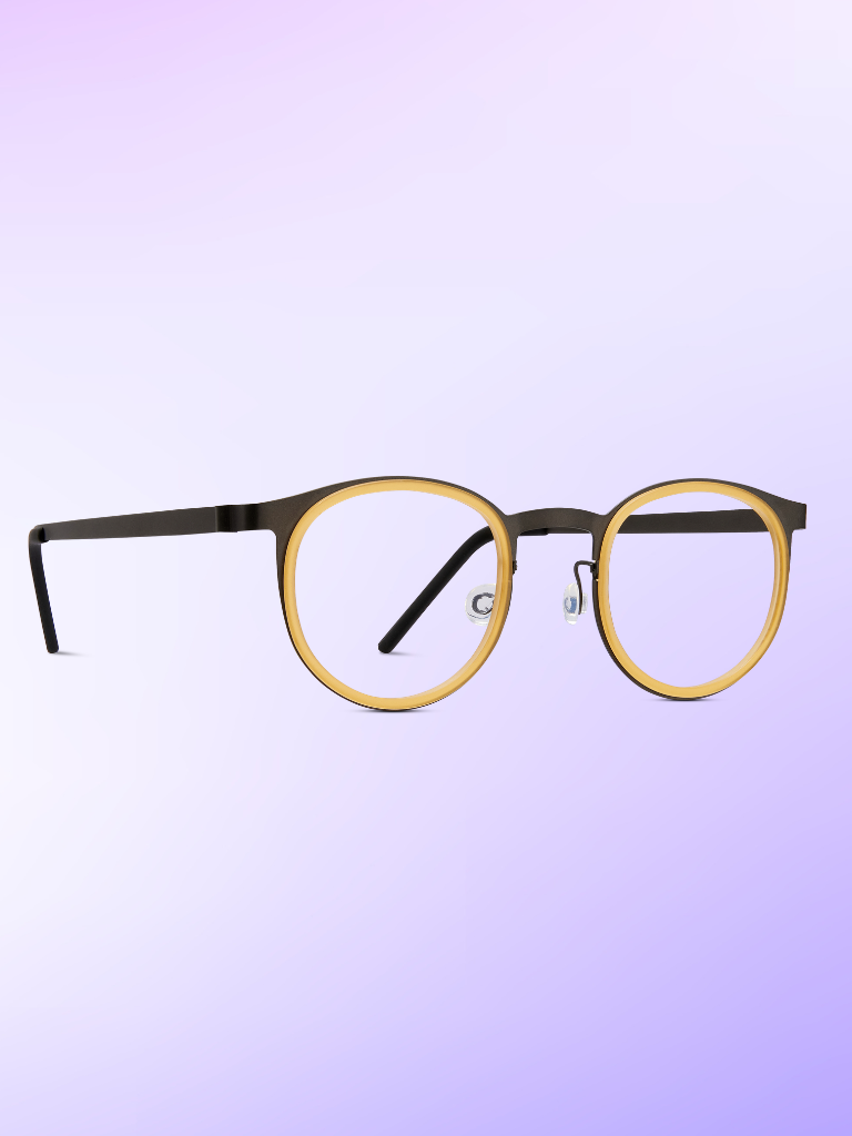 Round eyeglasses with black temples and yellow rims, photographed on a soft purple gradient background.